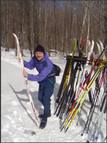 Ken waxes his skis outside Lusk Cabin